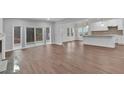 Open living room featuring hardwood floors, fireplace, and sliding glass doors at 250 Stonecreek Pkwy, Covington, GA 30016