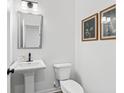 Elegant half bathroom with pedestal sink and neutral-toned walls at 3378 Pepperpike Ct, Loganville, GA 30052