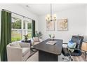 Bright home office with large windows, neutral decor, and modern chandelier at 3378 Pepperpike Ct, Loganville, GA 30052