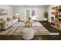 Bright living room featuring a modern rug, comfortable seating, built-in shelving, and access to the backyard at 2492 Brentwood Ct, Decatur, GA 30032
