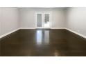 Bright living room featuring access to the backyard and freshly refinished hardwood floors at 2492 Brentwood Ct, Decatur, GA 30032