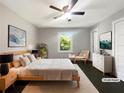 Serene primary bedroom with a ceiling fan, neutral tones, and a view of the backyard at 2492 Brentwood Ct, Decatur, GA 30032