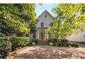 Charming two-story home with stone steps leading to the green front door and a large pea gravel driveway at 2493 Oldfield Nw Rd, Atlanta, GA 30327