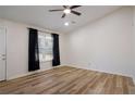 Spacious living room featuring wood-look floors and a ceiling fan at 158 Ashwood Ct, Riverdale, GA 30274