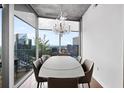 Bright dining room with modern chandelier, dining table and beautiful city views at 3324 Peachtree Ne Rd # 2718, Atlanta, GA 30326