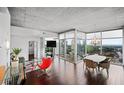An open living room with hardwood floors, floor-to-ceiling windows, and modern decor at 3324 Peachtree Ne Rd # 2718, Atlanta, GA 30326