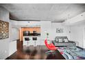 Open-concept living space with dark hardwood floors and modern furnishings at 3324 Peachtree Ne Rd # 2718, Atlanta, GA 30326
