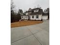 House exterior with landscaping and a circular driveway at 3730 Reserve Overlook (Lot 8) Way, Cumming, GA 30041