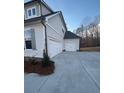 Three car garage with white doors and light gray siding at 3730 Reserve Overlook (Lot 8) Way, Cumming, GA 30041