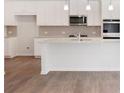 Modern kitchen featuring white cabinets and granite countertops at 704 Hedwig Dr Lot 90, Mcdonough, GA 30252