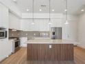 Modern kitchen with stainless steel appliances and island at 675 Drewry Ne St # 205, Atlanta, GA 30306