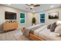 Cozy main bedroom with carpet, ceiling fan, large window and dresser with drawers at 89 Elsberry Rd, Dallas, GA 30157