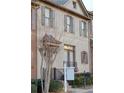 Townhouse exterior featuring brick facade, shutters, and a small front yard at 10785 Arlington Pt, Alpharetta, GA 30022