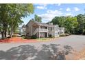 Condo building featuring lush landscaping and ample parking space for residents and visitors at 707 Augusta Se Dr, Marietta, GA 30067