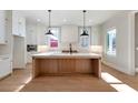 Spacious kitchen with island, white cabinets, and hardwood floors at 145 Cedarwood Ln, Roswell, GA 30075