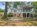 Home's back features a large sunroom and flagstone patio at 5622 Williamsburg Dr, Norcross, GA 30093