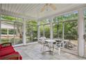 Bright sunroom with tiled floor, wicker furniture, and sliding glass doors at 5622 Williamsburg Dr, Norcross, GA 30093