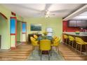 Dining room featuring a modern table and chairs, with adjacent kitchen and colorful design at 112 Camelot Dr, Atlanta, GA 30349
