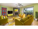 Bright living room features a stone fireplace, wood floors, and sliding glass door to the balcony at 112 Camelot Dr, Atlanta, GA 30349