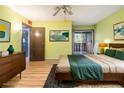 Bedroom with sliding glass doors to balcony, wood dresser, and a comfortable bed at 112 Camelot Dr, Atlanta, GA 30349