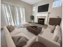 Inviting living room featuring ample seating, a fireplace, and neutral decor at 4337 Ben Hill Rd, Atlanta, GA 30349