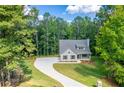 House nestled in a wooded area with a long driveway at 939 Jean Ct, Covington, GA 30014