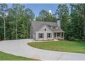 Gray siding house with a large yard and circular driveway at 939 Jean Ct, Covington, GA 30014