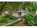 Quaint home featuring a lovely garden, a well-manicured lawn, and a welcoming front porch at 978 W Mill Bnd, Kennesaw, GA 30152