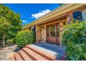 Beautiful front porch with a stone wall, brick stairs and a double door at 3700 Tom Brewer Rd, Loganville, GA 30052