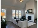 Cozy living room showcasing a fireplace, ample natural light, and stylish furnishings at 507 Godfrey Dr, Cumming, GA 30040