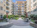 Picturesque courtyard with tables, chairs, and a central fountain offering an inviting outdoor space for residents at 230 E Ponce De Leon Ave # 322, Decatur, GA 30030