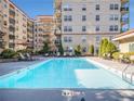A large, rectangular pool is surrounded by lounge chairs and tables, perfect for outdoor relaxation at 230 E Ponce De Leon Ave # 322, Decatur, GA 30030