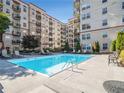 An inviting swimming pool surrounded by lounge chairs and lush landscaping for relaxation at 230 E Ponce De Leon Ave # 322, Decatur, GA 30030
