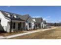 A row of beautiful modern farmhouse style homes in a peaceful, walkable community with sidewalks at 503 Godfrey Dr, Cumming, GA 30040