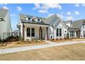Beautiful new construction home with white siding, a manicured lawn, and a cozy front porch at 505 Godfrey Dr, Cumming, GA 30040