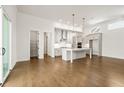 Open-concept kitchen with modern appliances, island, hardwood floors and ample cabinet space at 505 Godfrey Dr, Cumming, GA 30040