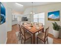 Dining room featuring wood floors, a classic chandelier, and a dining table with seating for six at 3076 Harris Mill Ct, Duluth, GA 30096