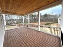 Spacious covered porch with wooden ceiling and wooded view at 1077 Sweet Mia Ln, Powder Springs, GA 30127