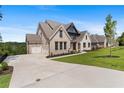 Two-story house with attached garage and driveway, on a landscaped lot at 5693 Brendlynn Dr, Suwanee, GA 30024