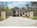 View of the house from the end of the driveway, with pillars on either side at 2861 Tree Top Rd, Dacula, GA 30019