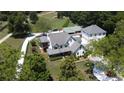 Expansive aerial view of the stunning home with a manicured lawn, additional buildings, and a long winding driveway at 3898 Ridge Rd, Buford, GA 30519