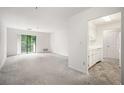 Open living room with a view into kitchen and access to balcony at 300 Johnson Ferry Ne Rd # A203, Sandy Springs, GA 30328