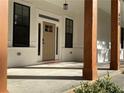 Covered front porch with wooden posts and a neutral colored door at 408 Autry St, Norcross, GA 30071