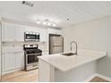 Modern kitchen with quartz countertops, stainless steel appliances, and white cabinets at 4315 Orchard Park Ct, Stone Mountain, GA 30083