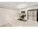 This kitchen has a large island with stainless steel sink and modern appliances at 4315 Orchard Park Ct, Stone Mountain, GA 30083