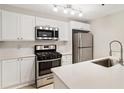 Bright kitchen features white cabinets, stainless steel appliances, and quartz countertops at 4315 Orchard Park Ct, Stone Mountain, GA 30083