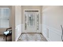 Bright entryway with white wainscoting and modern rug, creating a welcoming space at 5410 Whisper Ct, Cumming, GA 30028