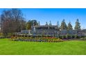 Beautiful Champions Run community entrance featuring colorful flowers and landscaping at 8593 Preakness Pass, Lithonia, GA 30058