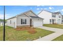 Attractive single-level home with a manicured lawn, an attached two-car garage, and conventional styling at 8593 Preakness Pass, Lithonia, GA 30058