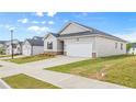 Comfortable one-story house with a green lawn, a convenient two-car garage, and familiar architectural touches at 8593 Preakness Pass, Lithonia, GA 30058